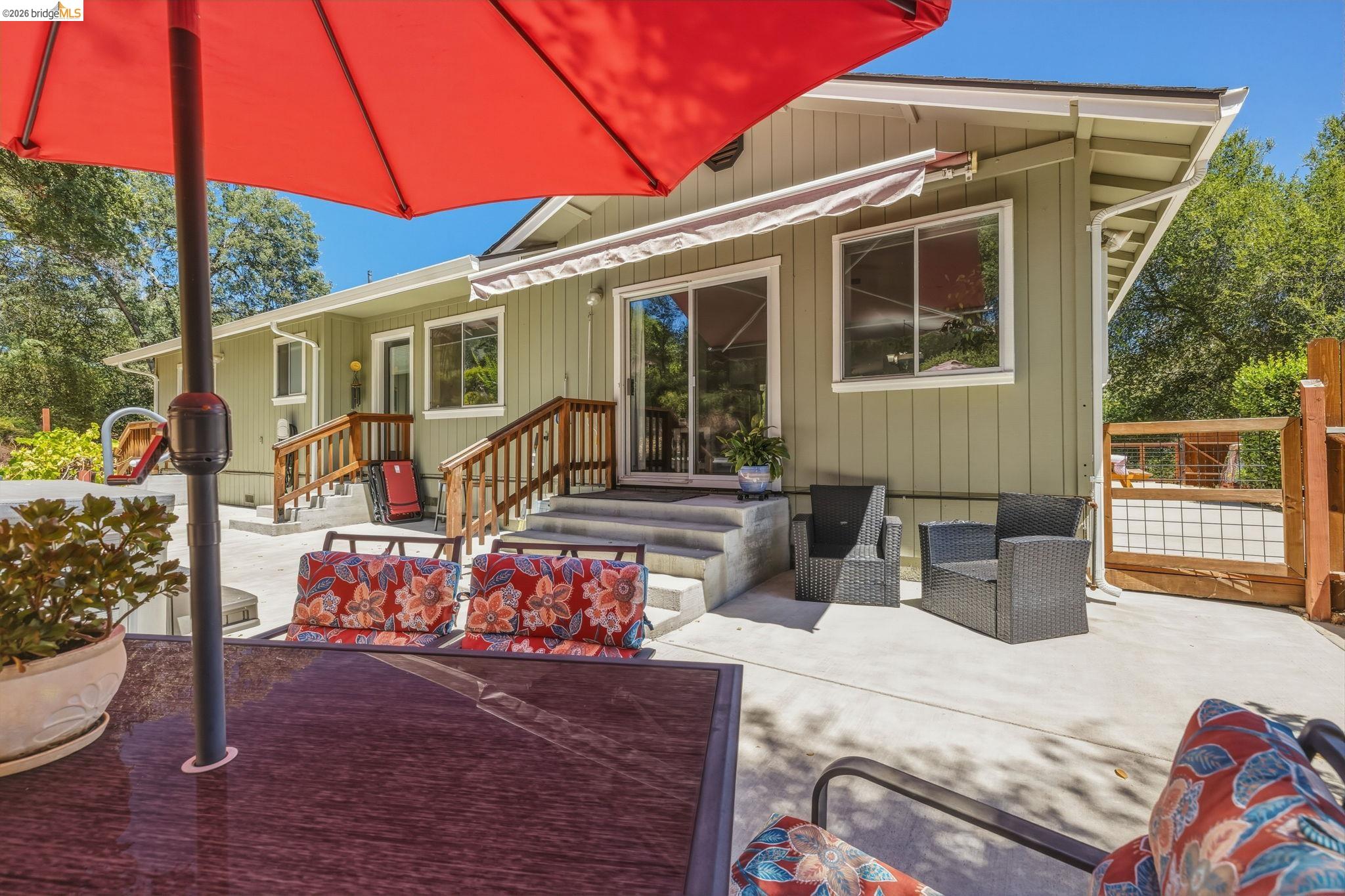 18570 Pradera Real Road Sonora, CA 95370 - Photo 54 of 66 Exterior featuring a light green facade, multiple windows, and a sliding glass door