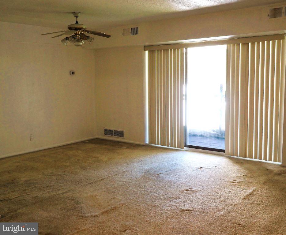 56 Welsh Tract Road, Unit 310 Newark, DE 19713 - Photo 4 of 16 an empty room with a window and a ceiling fan