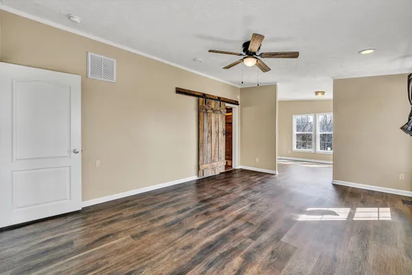 a view of empty room with wooden floor and fireplace