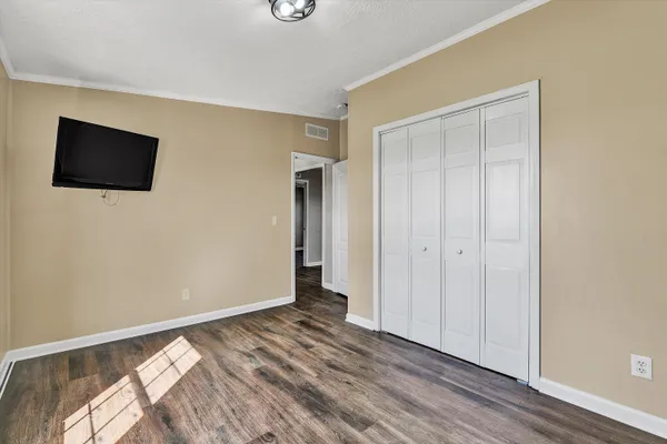 a view of an empty room and wooden floor