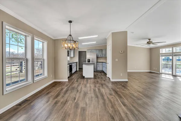 a kitchen with sink cabinets and wooden floor