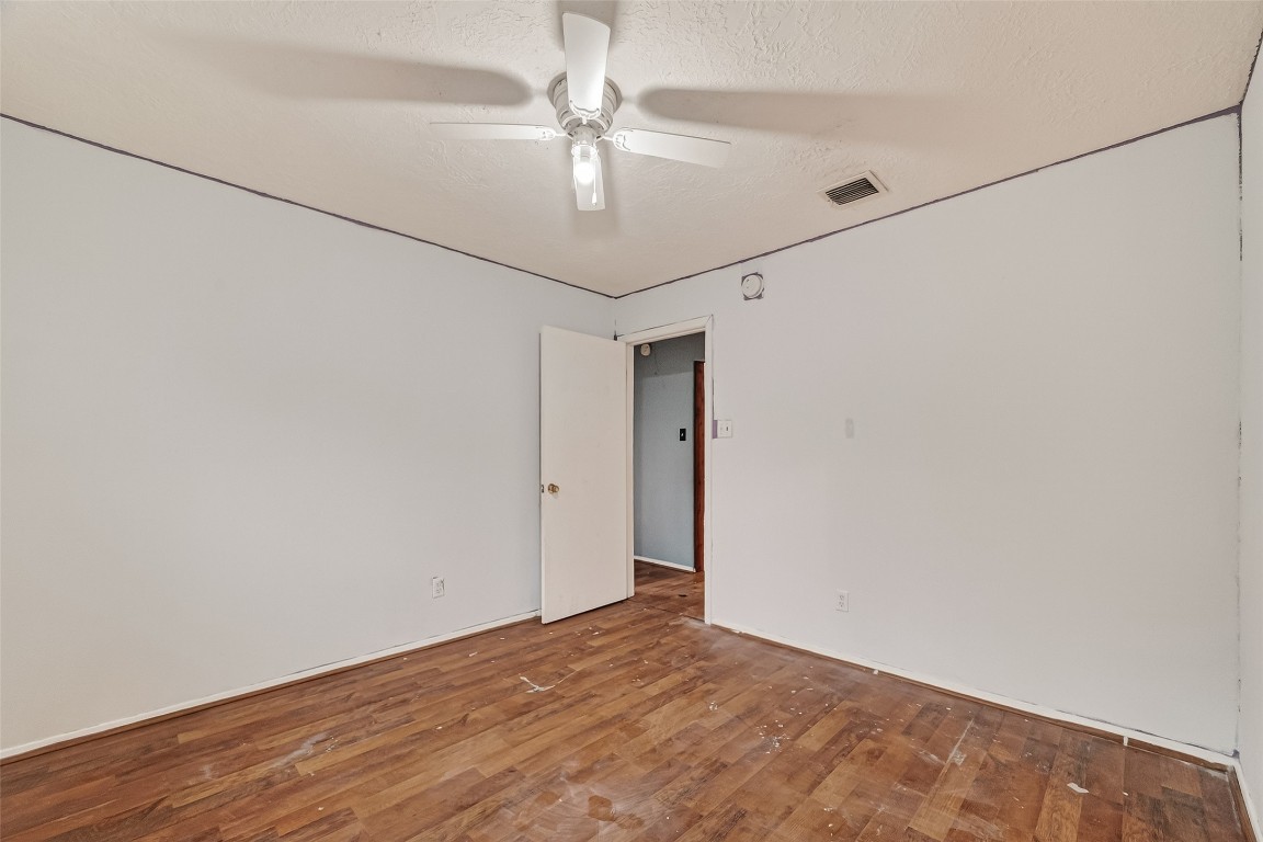 10135 Shell Rock Road La Porte, TX 77571 - Photo 11 of 17 an empty room with a ceiling fan and wooden floor
