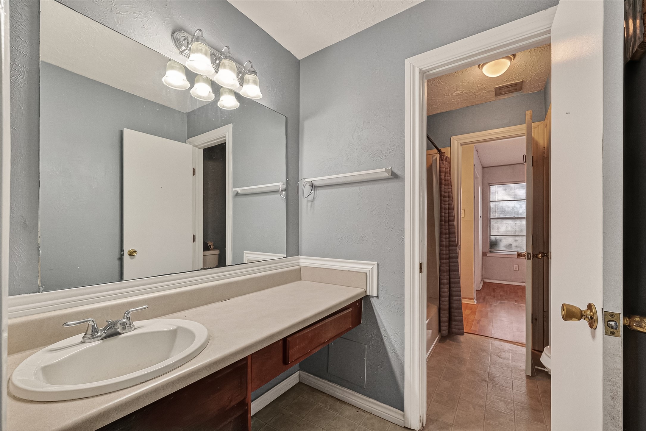 10135 Shell Rock Road La Porte, TX 77571 - Photo 13 of 17 a bathroom with a sink a light fixture and a mirror