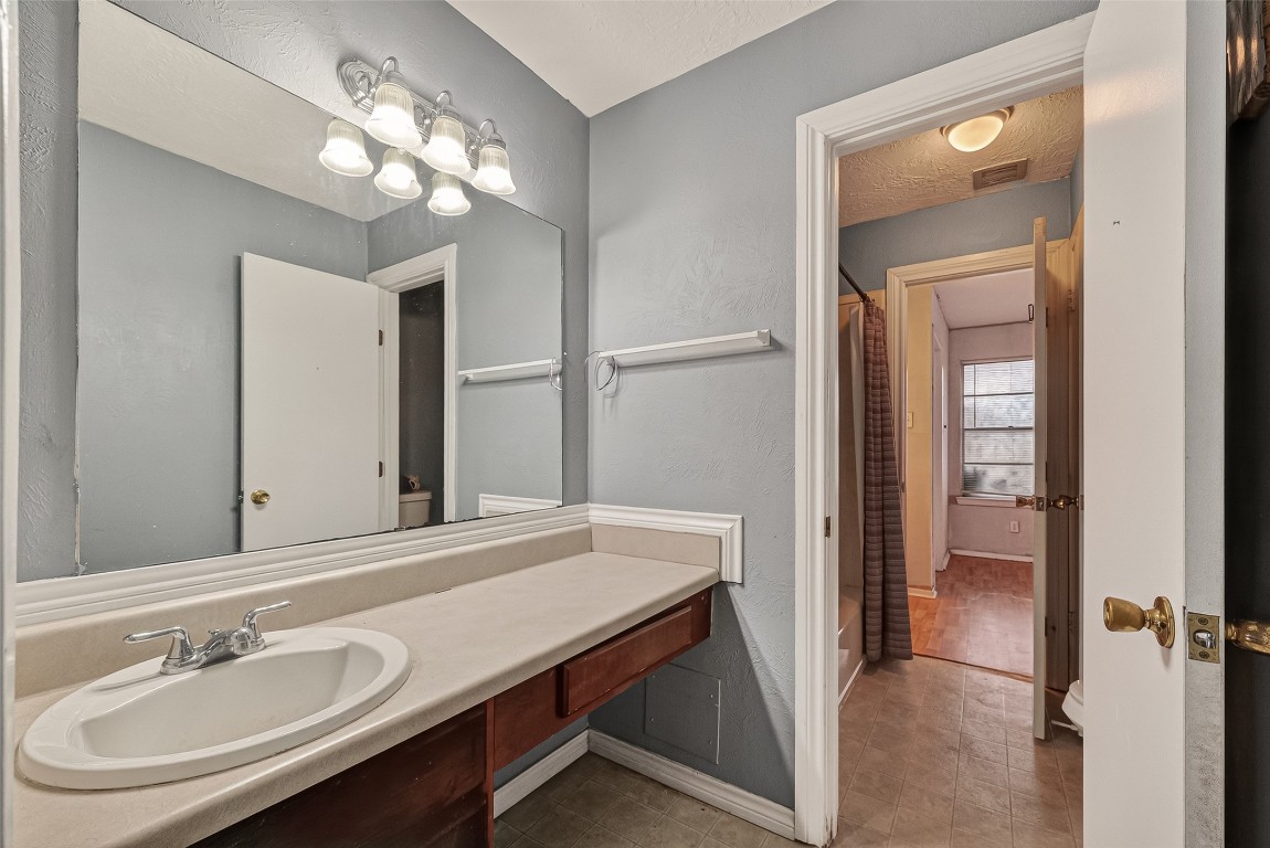 10135 Shell Rock Road La Porte, TX 77571 - Photo 13 of 17 a bathroom with a sink a light fixture and a mirror