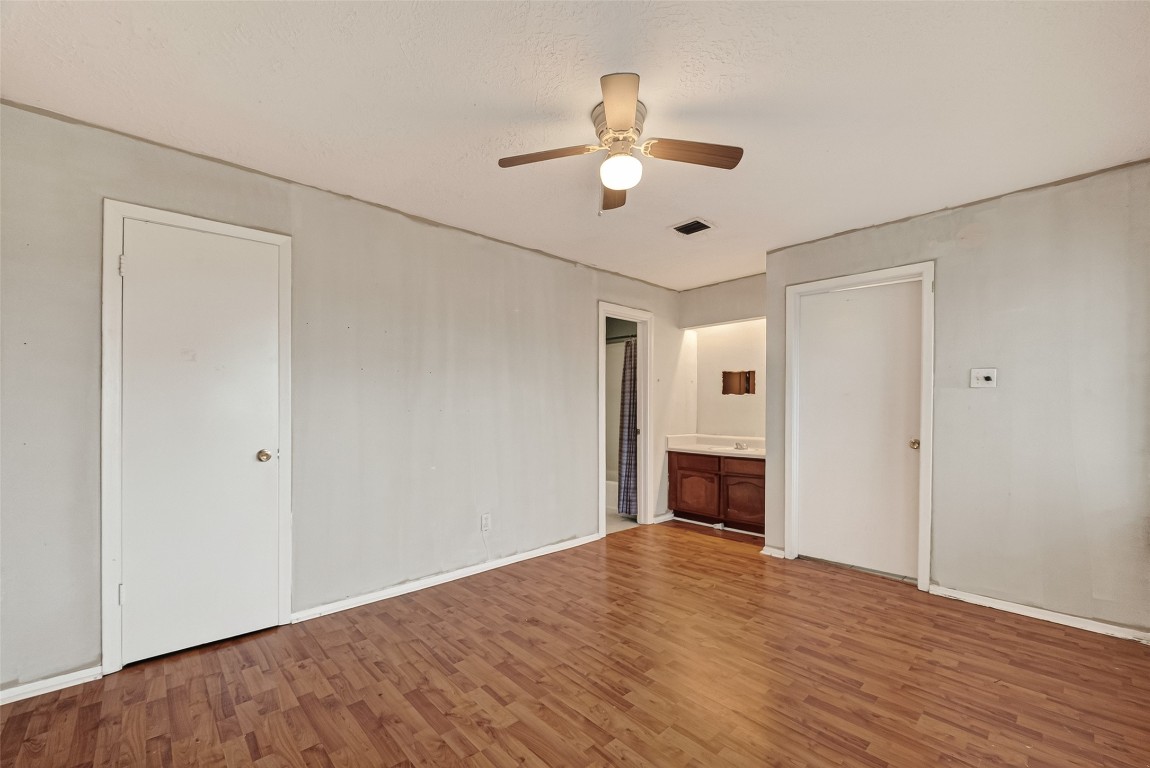 10135 Shell Rock Road La Porte, TX 77571 - Photo 15 of 17 a view of an empty room with wooden floor and a ceiling fan