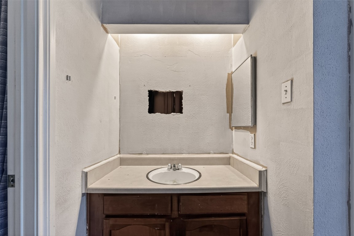 10135 Shell Rock Road La Porte, TX 77571 - Photo 16 of 17 a bathroom with a sink and a mirror