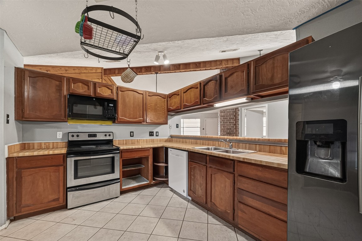 10135 Shell Rock Road La Porte, TX 77571 - Photo 7 of 17 a kitchen with stainless steel appliances granite countertop a stove and a microwave
