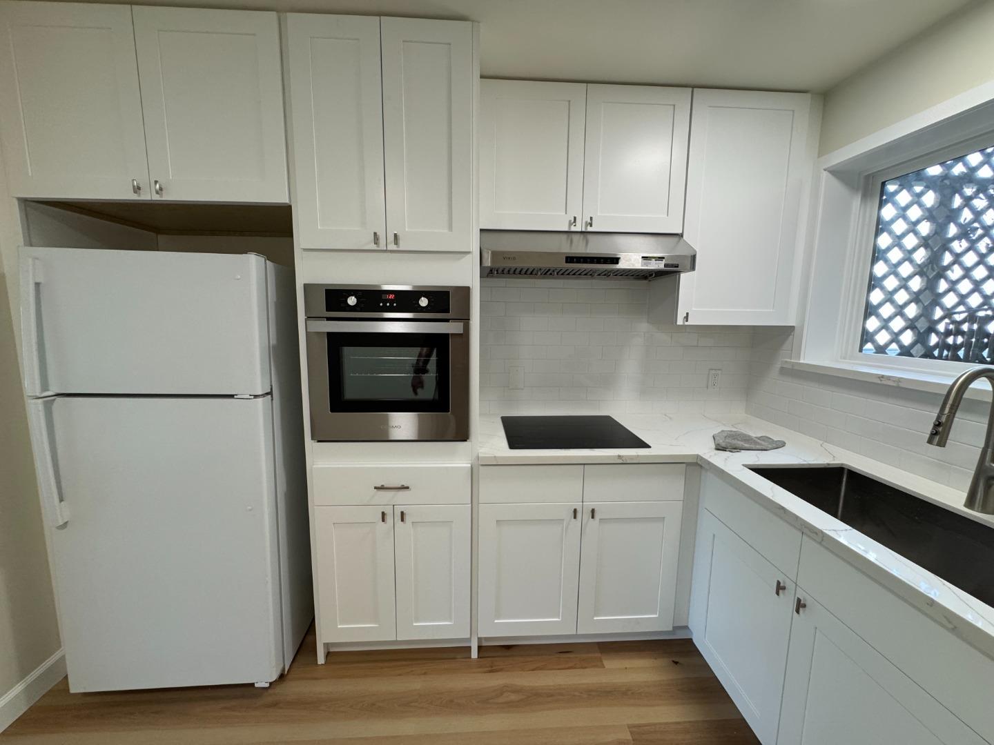 370 Bartlett Street, Unit 3 San Francisco, CA 94110 - Photo 13 of 35 a kitchen with cabinets appliances and a sink