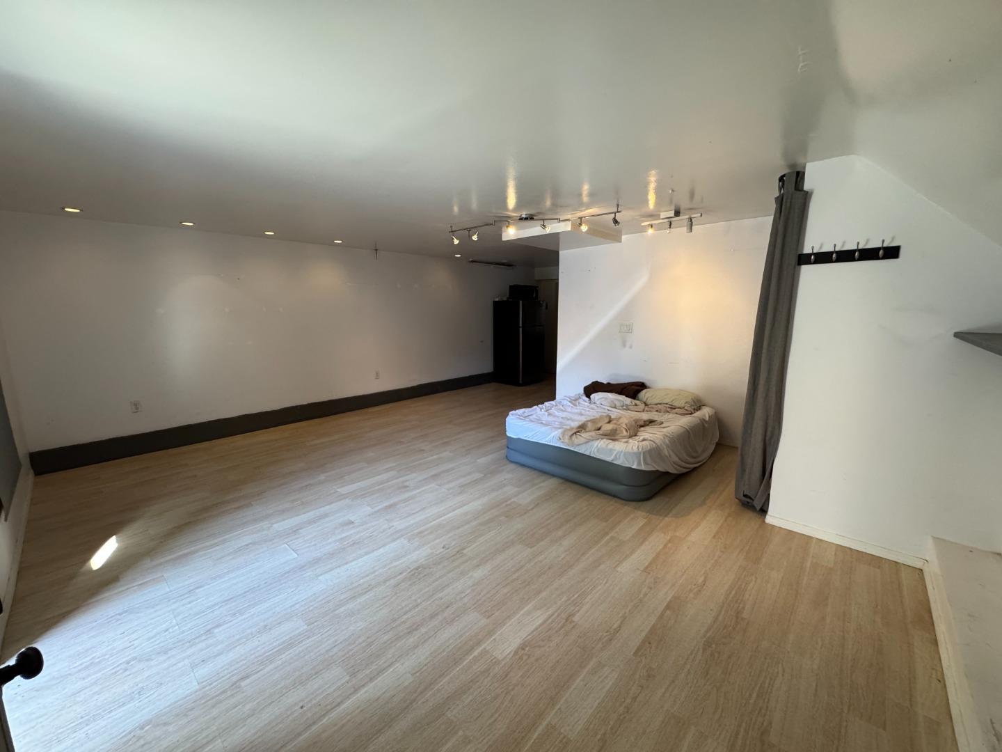 370 Bartlett Street, Unit 3 San Francisco, CA 94110 - Photo 31 of 35 a view of a room with wooden floor and couch