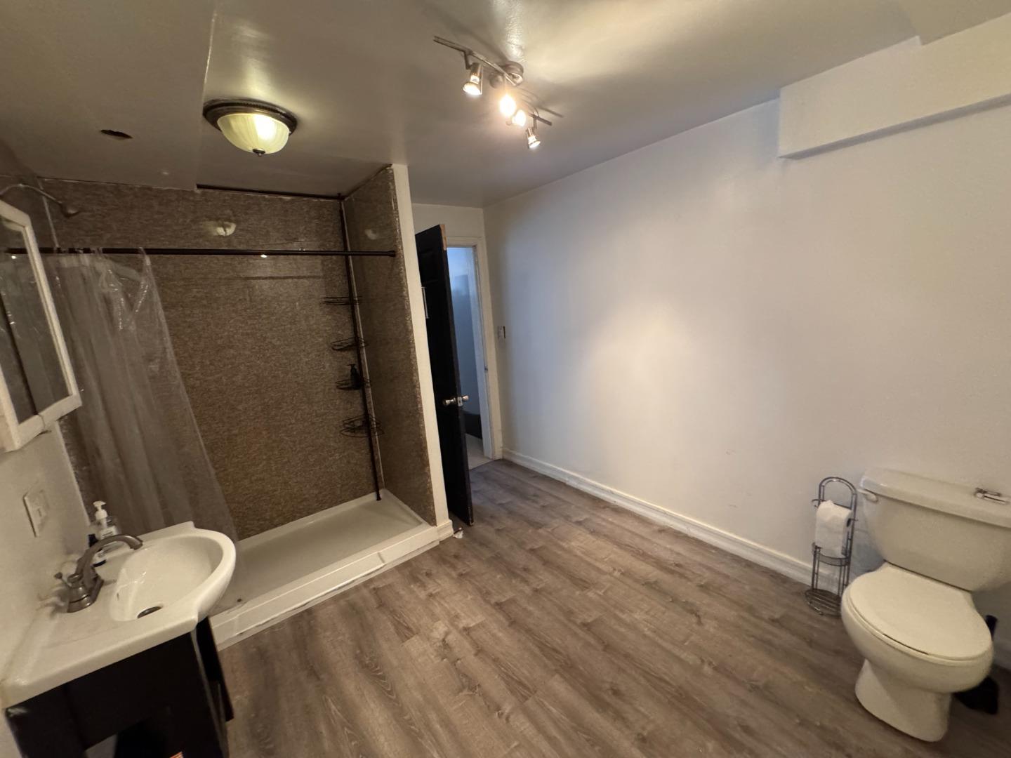 370 Bartlett Street, Unit 3 San Francisco, CA 94110 - Photo 33 of 35 a bathroom with a sink toilet and shower