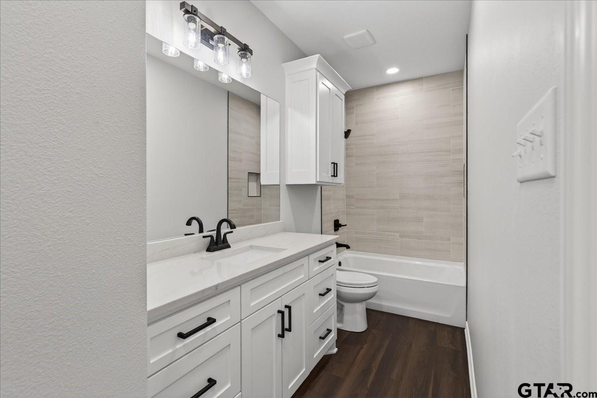 117 Bexar Mabank, TX 75147 - Photo 11 of 19 a bathroom with a double vanity sink toilet mirror and bathtub