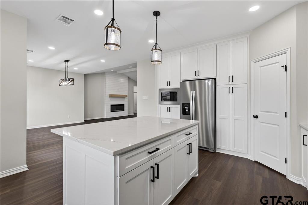 117 Bexar Mabank, TX 75147 - Photo 5 of 19 a kitchen with stainless steel appliances a refrigerator and a stove top oven