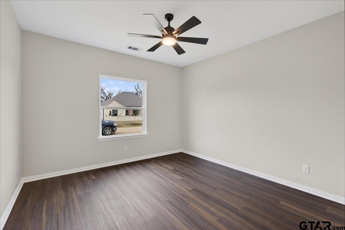 117 Bexar Mabank, TX 75147 - Photo 10 of 19 an empty room with wooden floor and windows