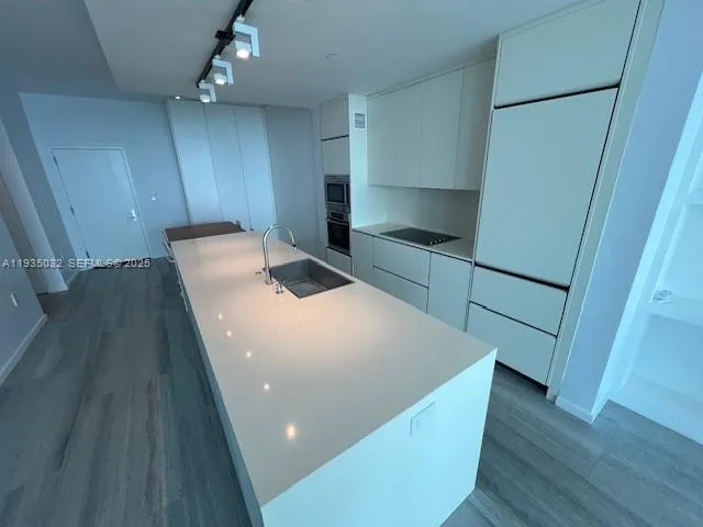 a view of a hallway with wooden floor and stairs