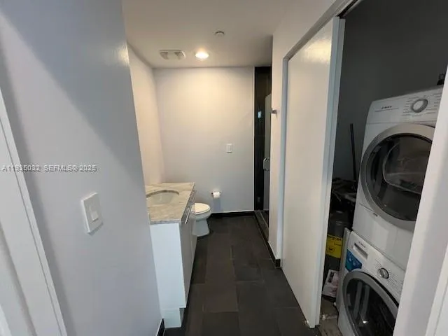 a bathroom with a toilet a sink and a mirror