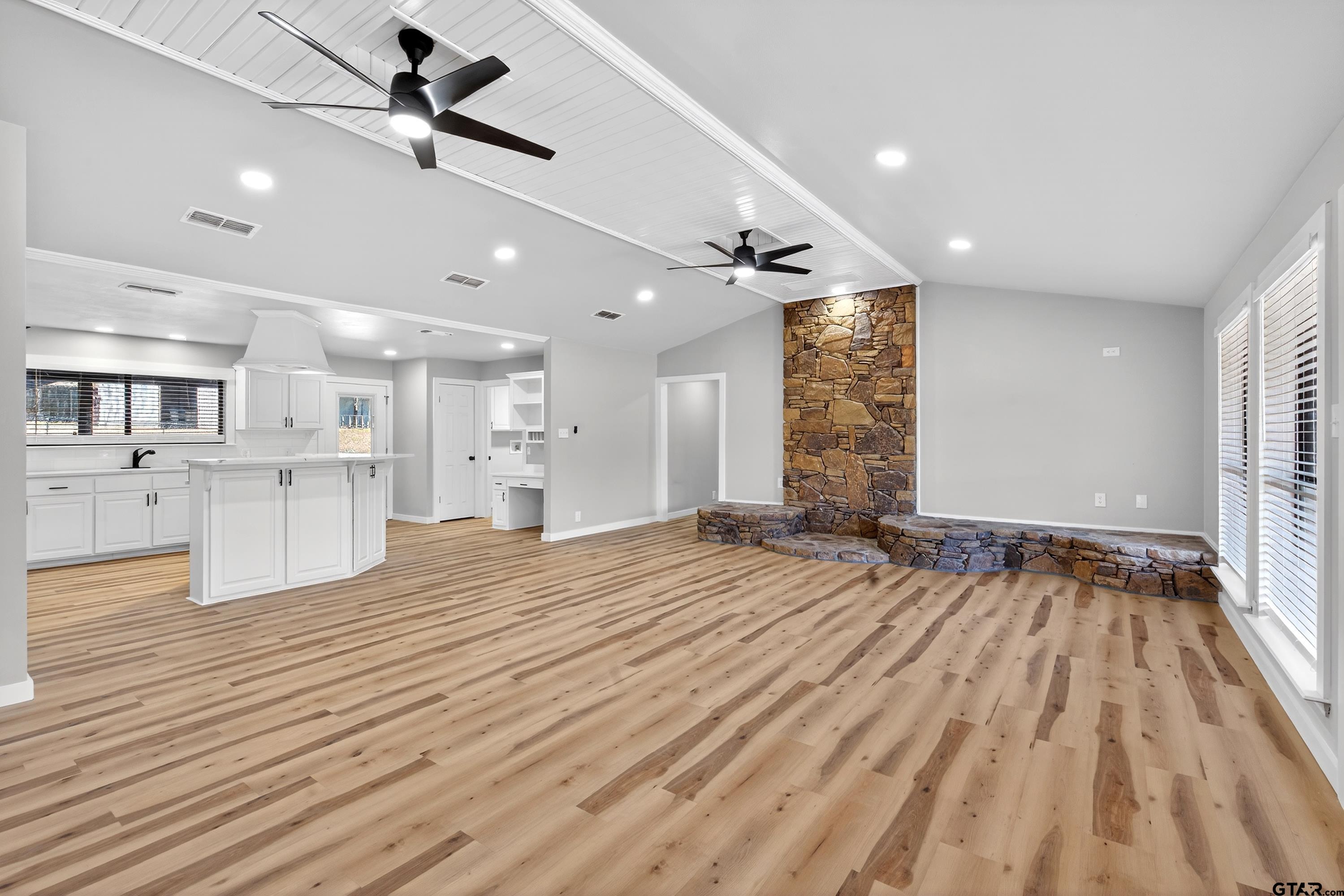 10418 East Fm 2011 Longview, TX 75603 - Photo 21 of 45 a view of an empty room with wooden floor and a kitchen