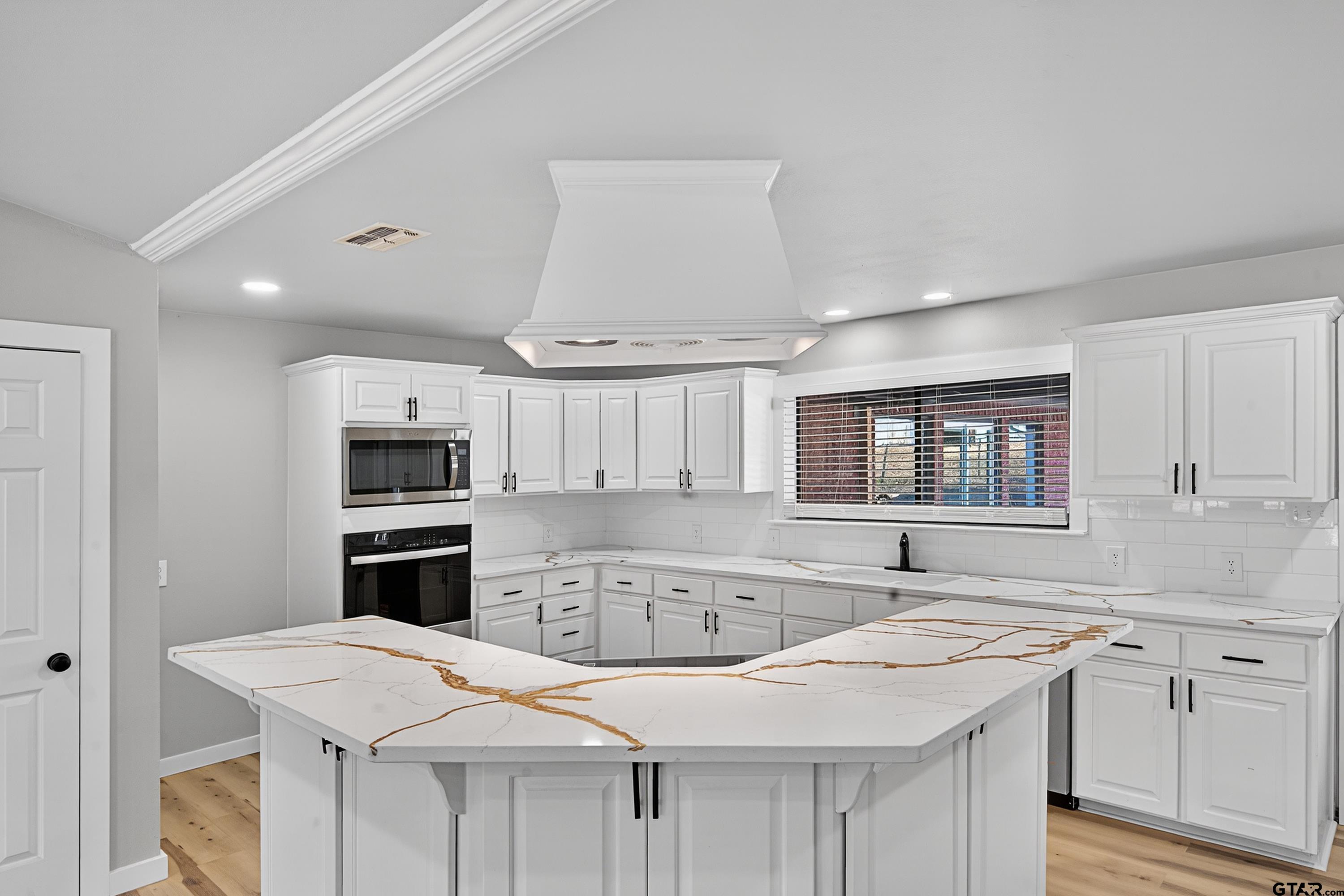 10418 East Fm 2011 Longview, TX 75603 - Photo 23 of 45 a kitchen with stainless steel appliances kitchen island a white cabinets sink and stove