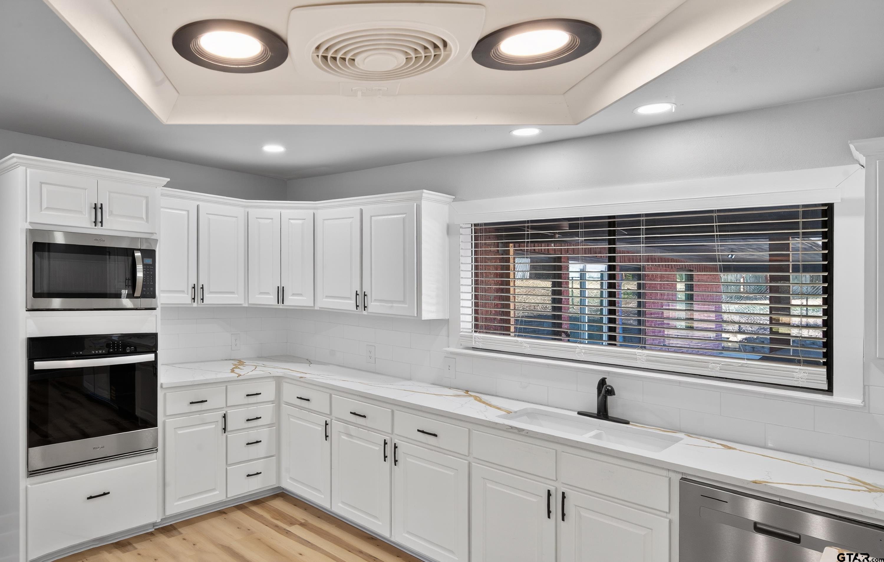 10418 East Fm 2011 Longview, TX 75603 - Photo 24 of 45 a kitchen with granite countertop a sink and a stove top oven