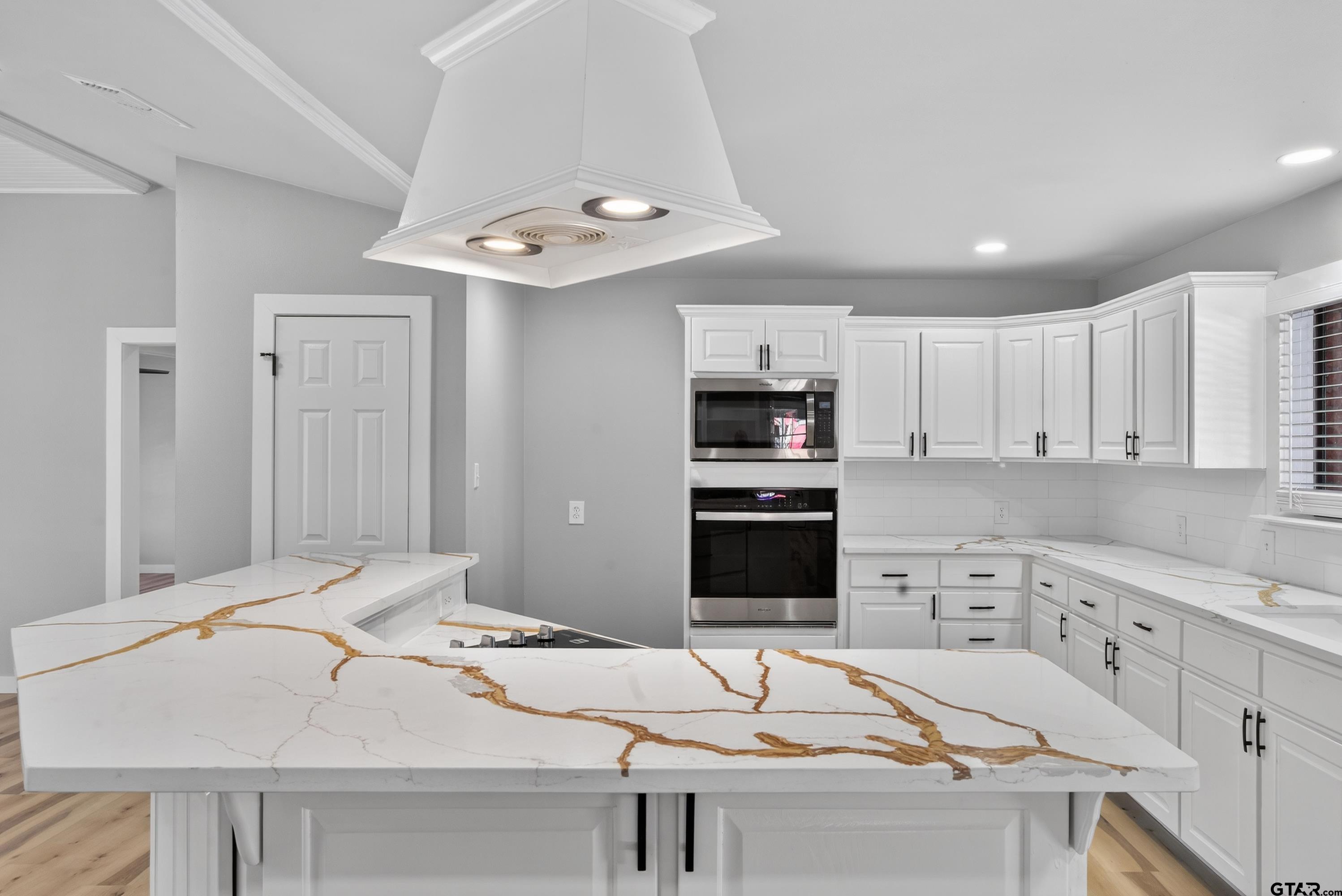 10418 East Fm 2011 Longview, TX 75603 - Photo 25 of 45 a kitchen with stainless steel appliances kitchen island granite countertop a sink and cabinets
