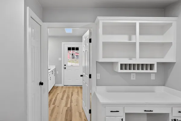 a kitchen with stainless steel appliances granite countertop a sink and a stove with white countertops