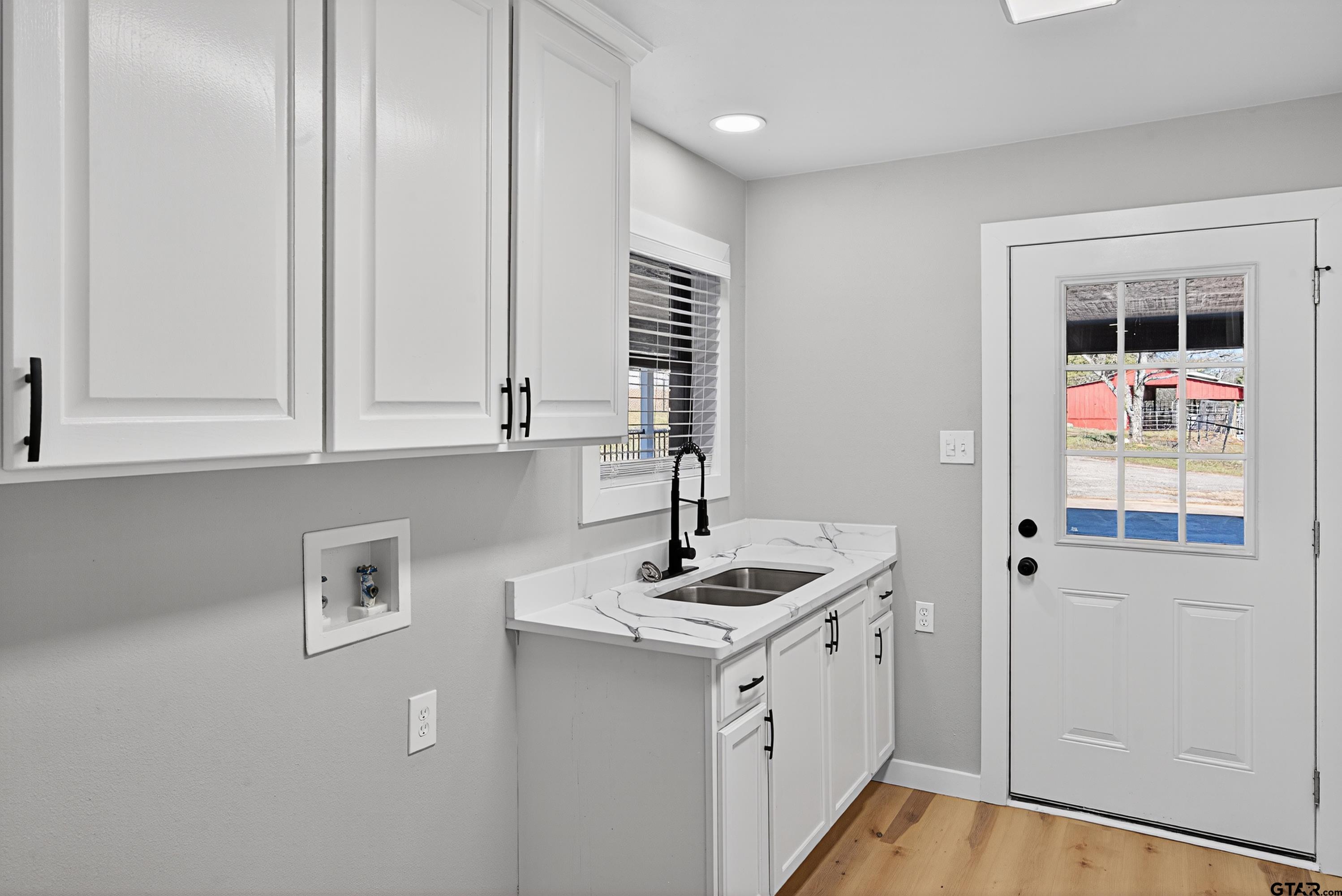 10418 East Fm 2011 Longview, TX 75603 - Photo 28 of 45 a kitchen with stainless steel appliances granite countertop a sink and a stove with white countertops