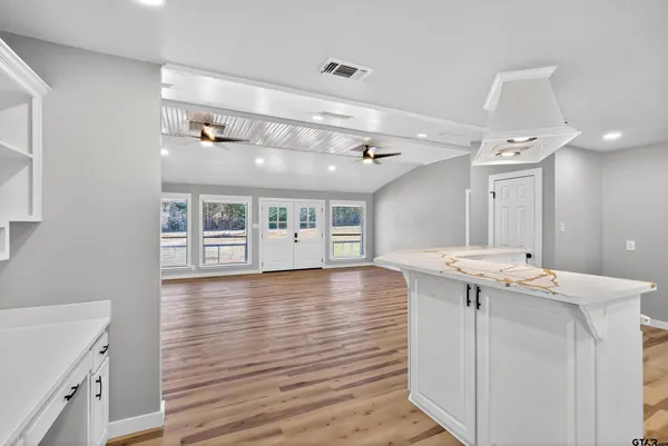 a large white kitchen with a large window