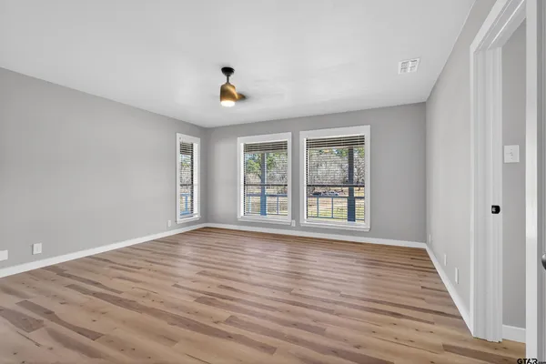 a spacious bedroom with a large bed and a window