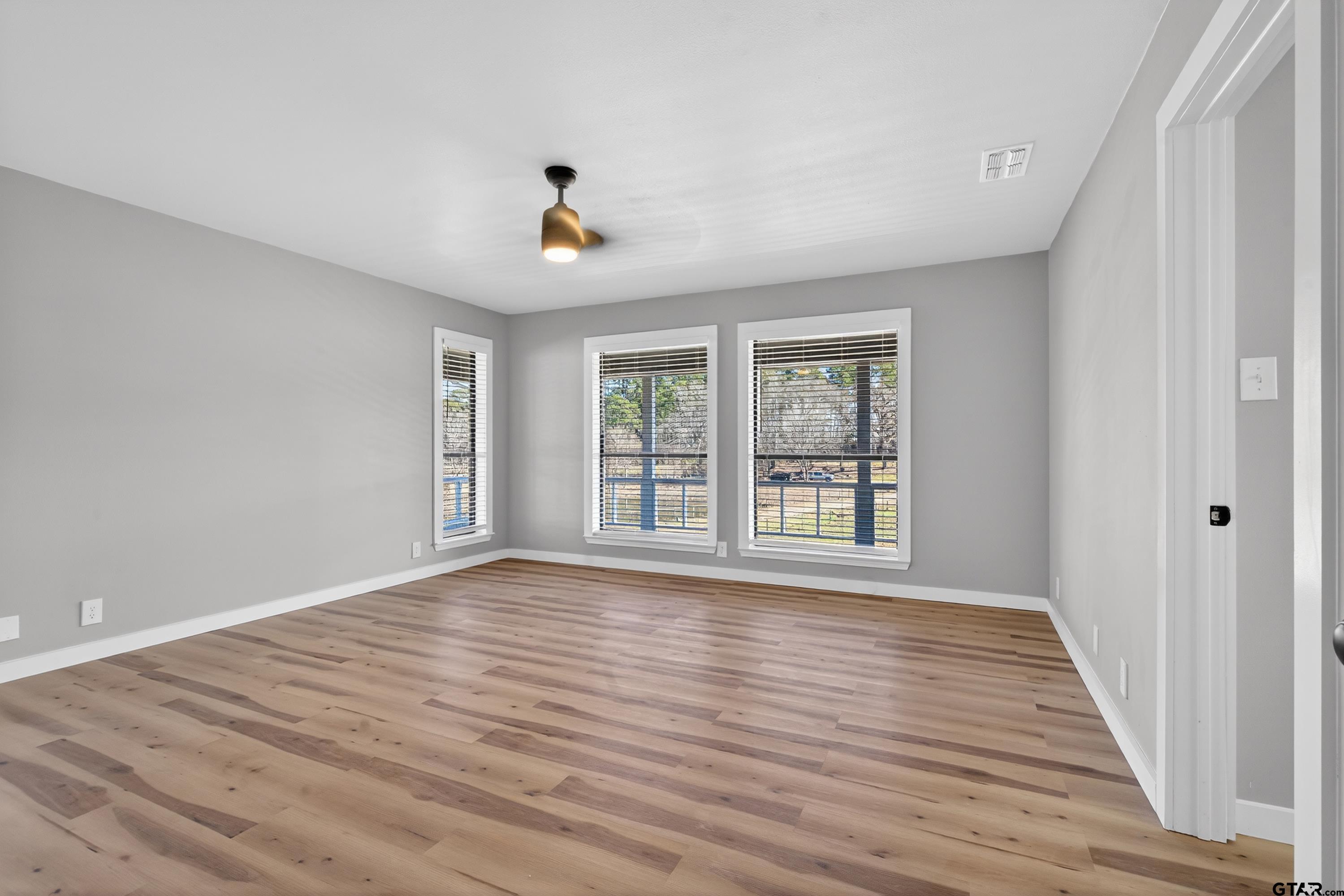 10418 East Fm 2011 Longview, TX 75603 - Photo 31 of 45 a view of an empty room with wooden floor and a window