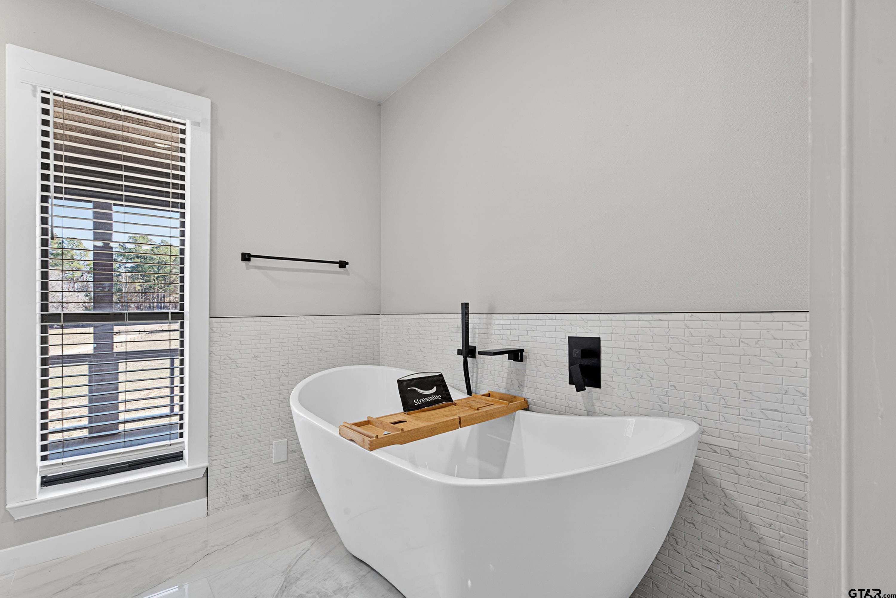10418 East Fm 2011 Longview, TX 75603 - Photo 34 of 45 a white bath tub sitting in a bathroom next to a window