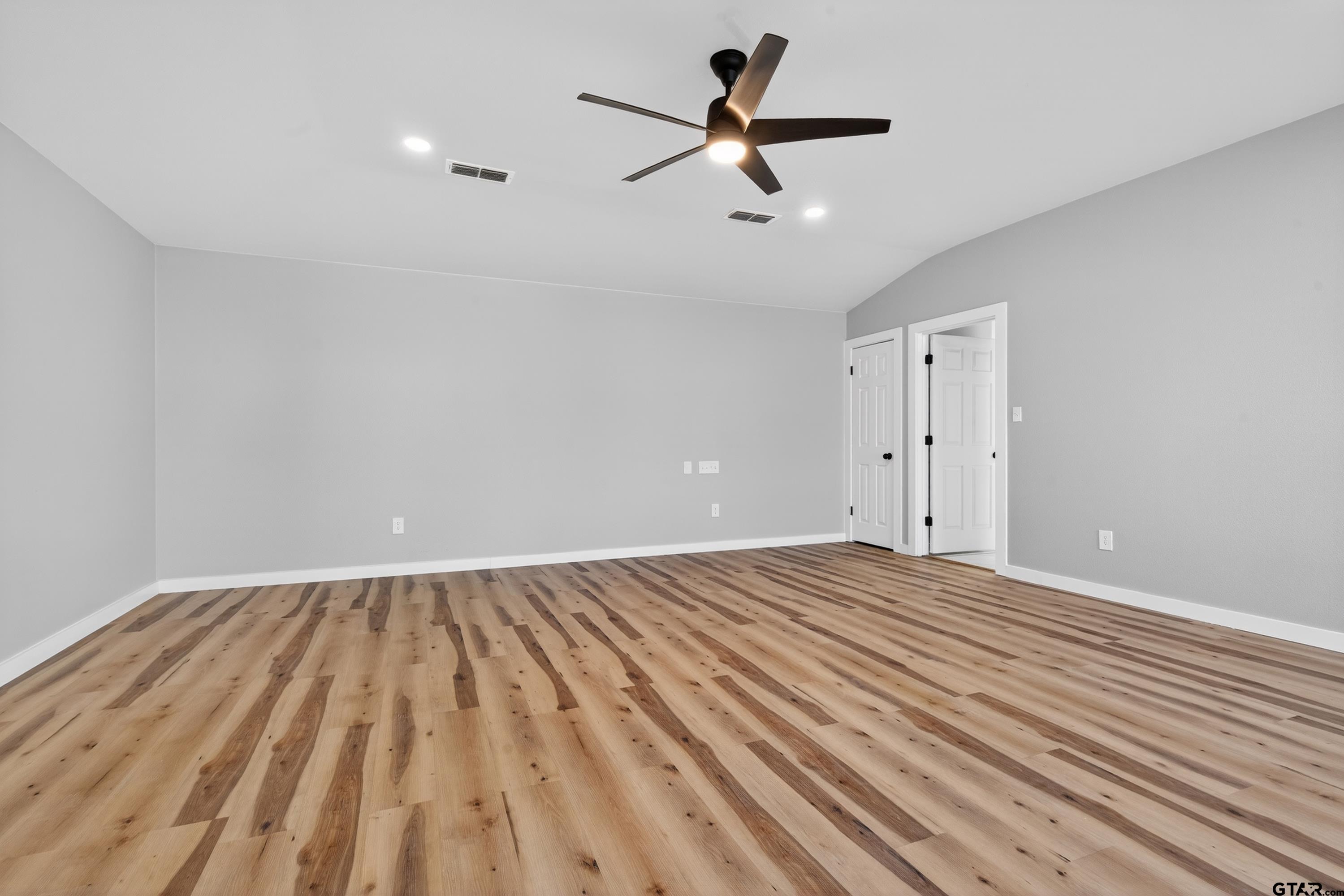 10418 East Fm 2011 Longview, TX 75603 - Photo 41 of 45 a view of empty room with wooden floor and ceiling fan