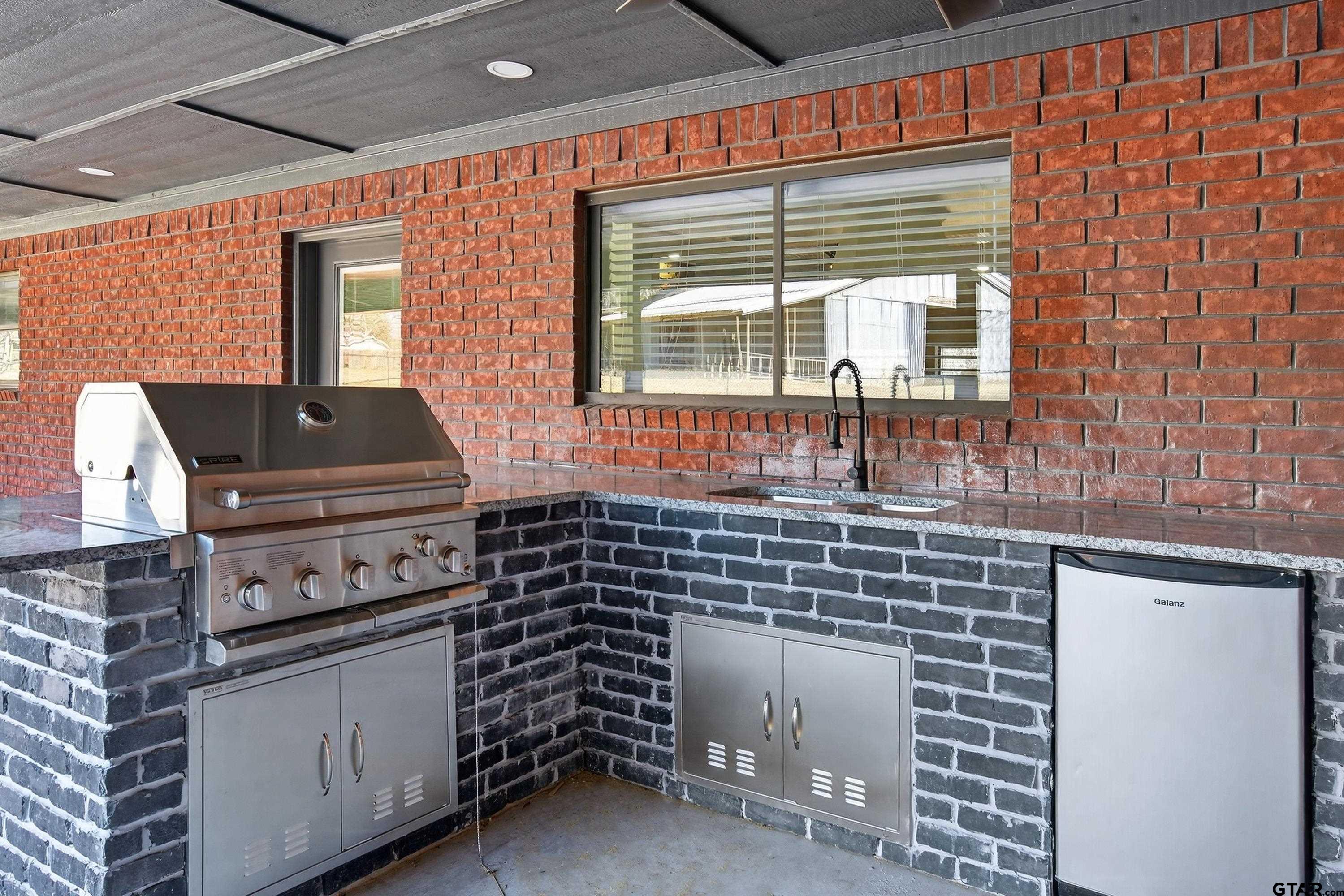 10418 East Fm 2011 Longview, TX 75603 - Photo 7 of 45 a kitchen with windows and brick wall