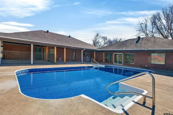 a view of swimming pool with outdoor seating