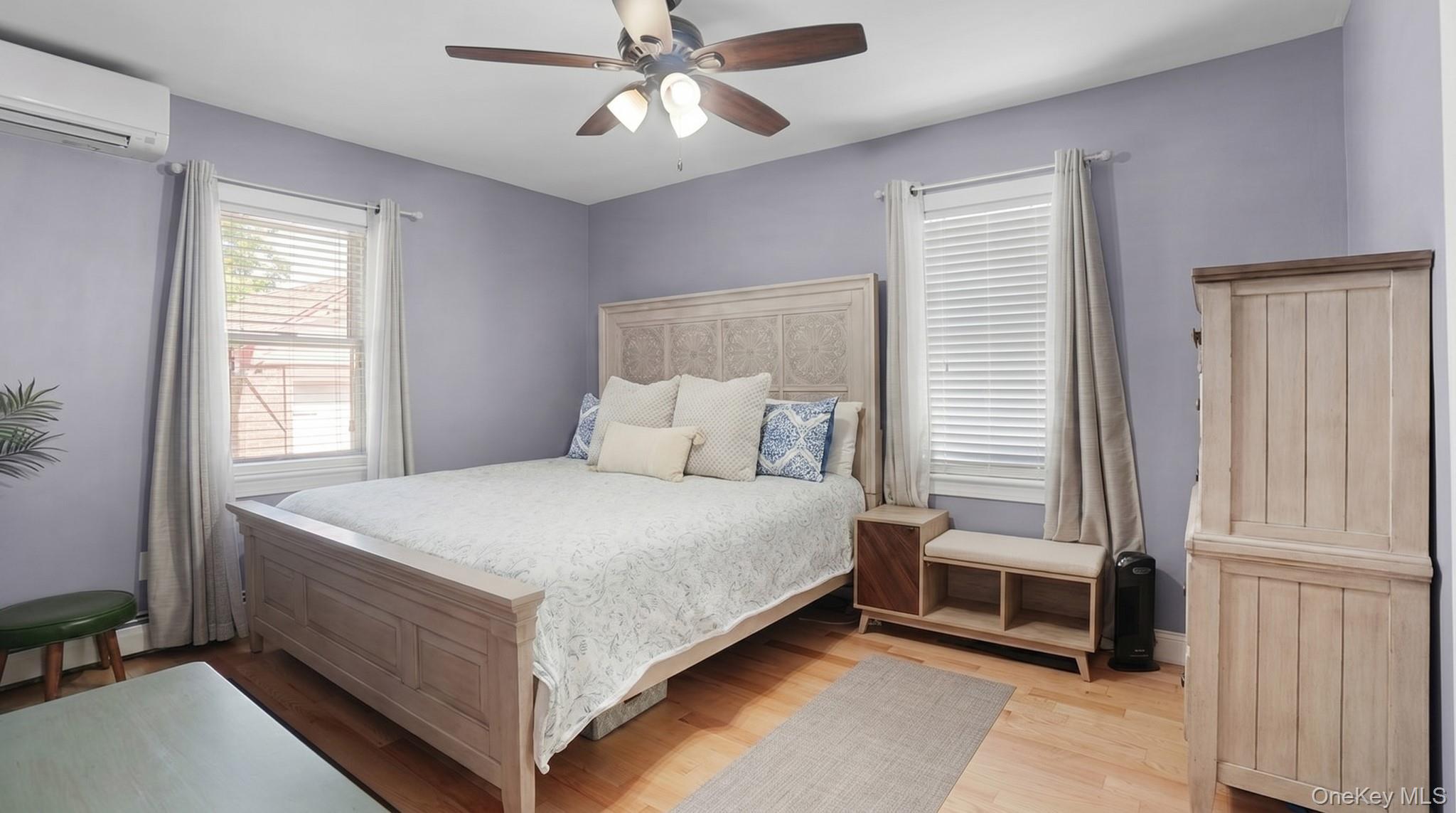 172-17 Amelia Road Queens, NY 11434 - Photo 10 of 18 a large bed sitting in a bedroom next to a window and a chandelier