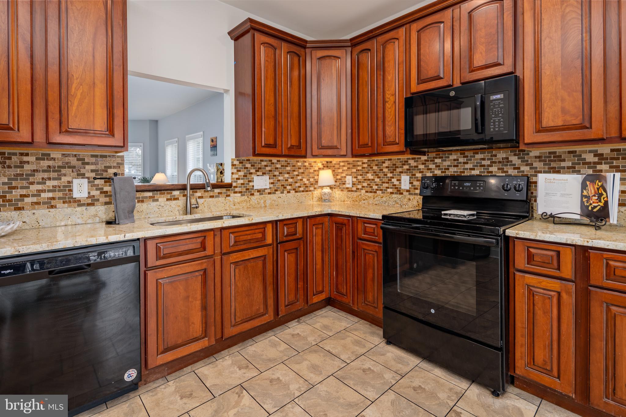 326 South Carolina Road Stevensville, MD 21666 - Photo 11 of 48 a kitchen with granite countertop stainless steel appliances a stove sink and microwave