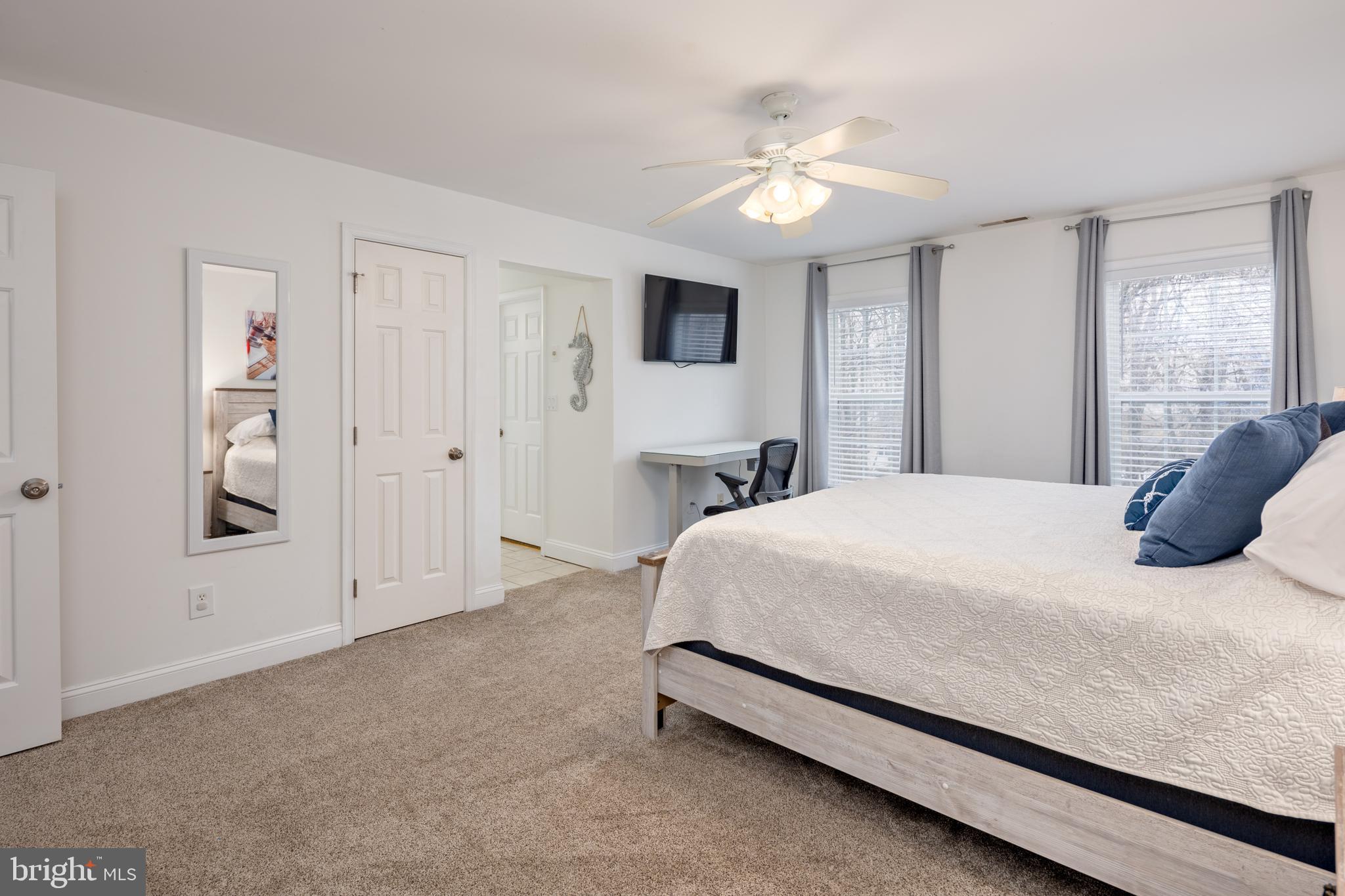 326 South Carolina Road Stevensville, MD 21666 - Photo 20 of 48 a bedroom with a bed and a chandelier