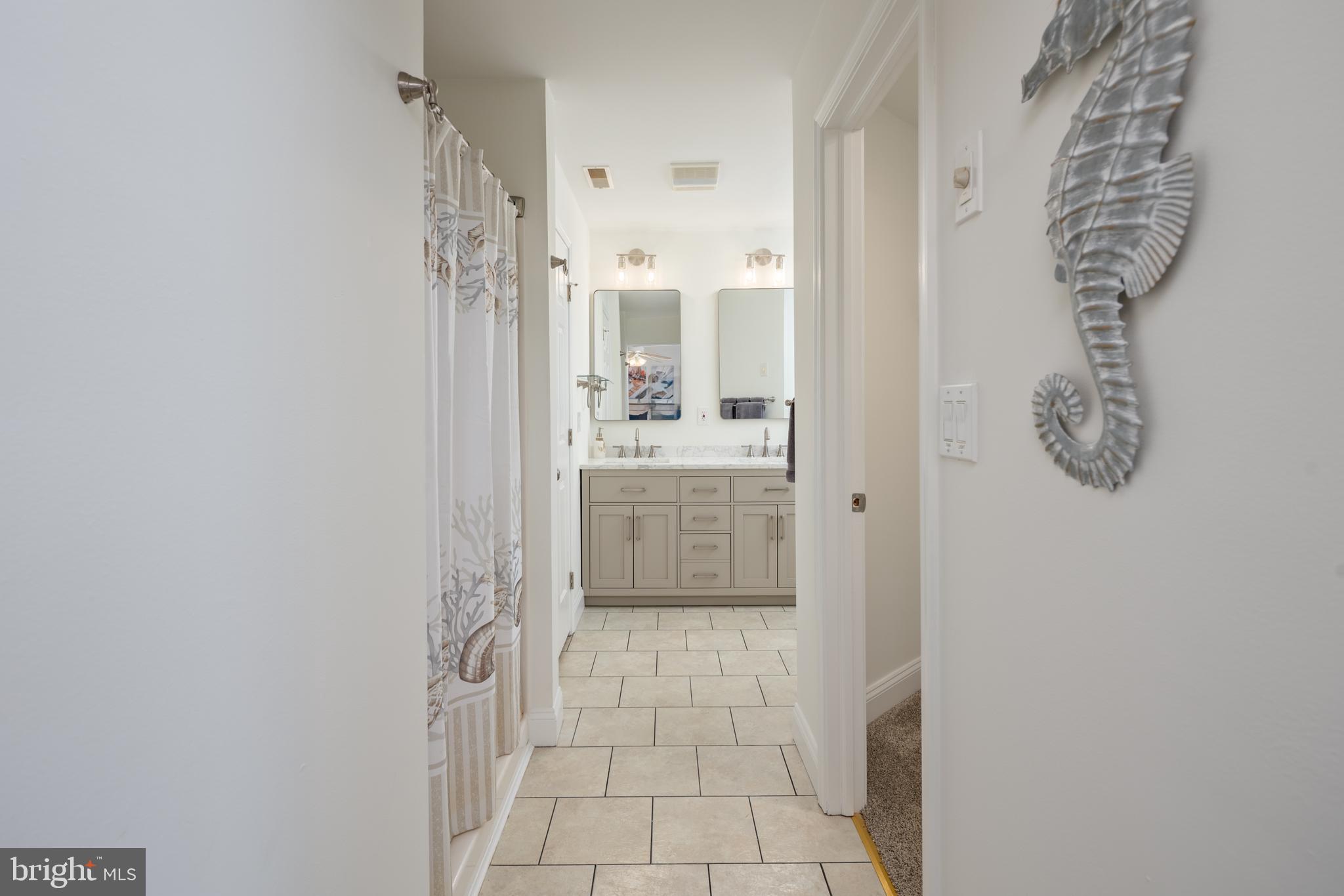 326 South Carolina Road Stevensville, MD 21666 - Photo 21 of 48 a bathroom with a granite countertop shower a sink and a mirror