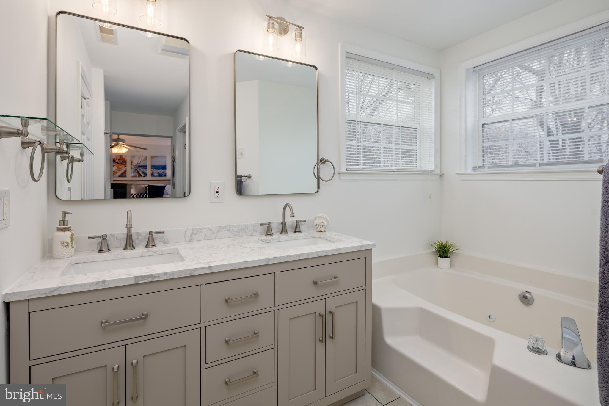 326 South Carolina Road Stevensville, MD 21666 - Photo 23 of 48 a bathroom with a tub a sink and mirror