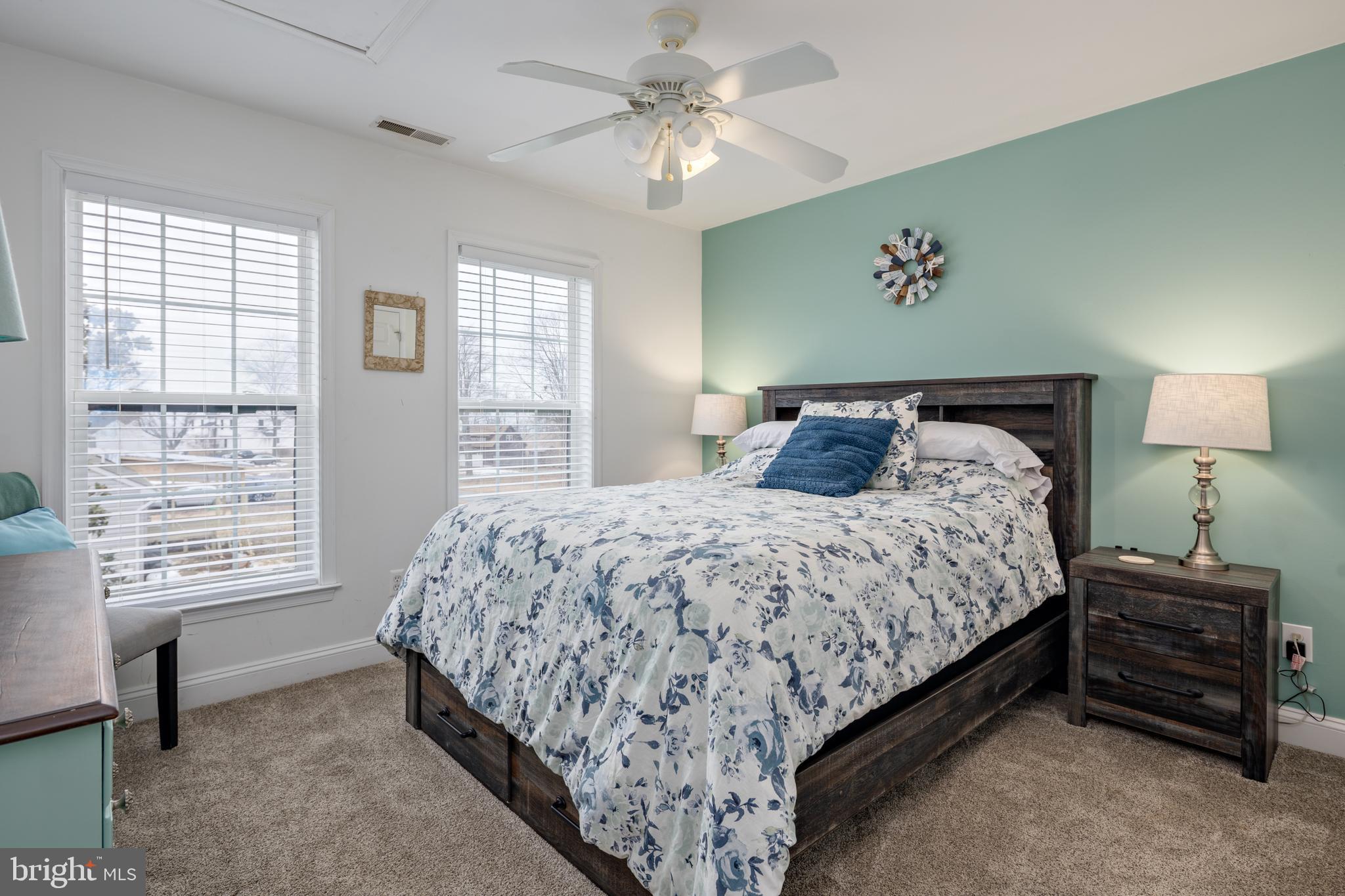 326 South Carolina Road Stevensville, MD 21666 - Photo 28 of 48 a bedroom with a bed and a chandelier