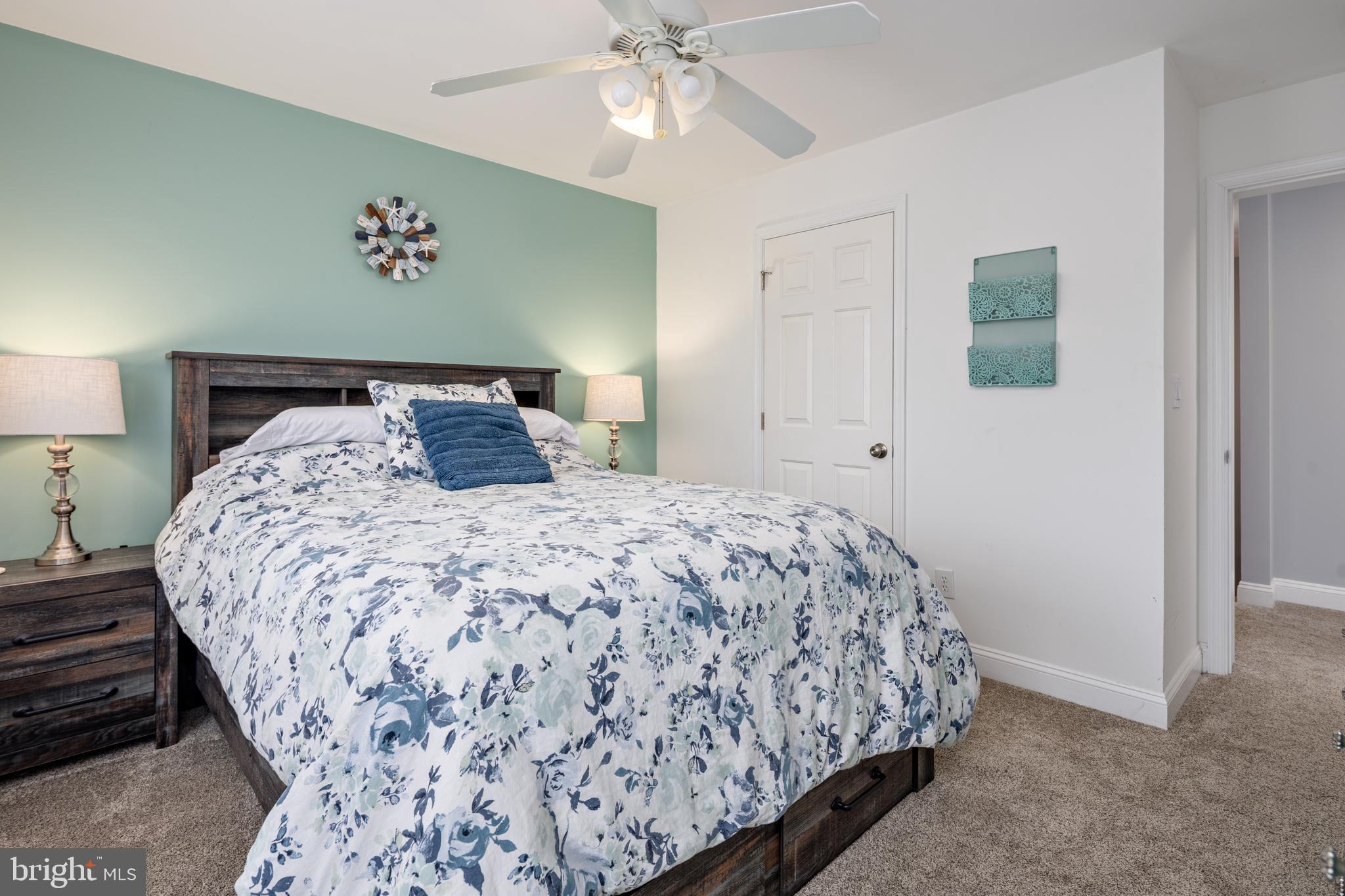 326 South Carolina Road Stevensville, MD 21666 - Photo 29 of 48 a bedroom with a bed and a chandelier