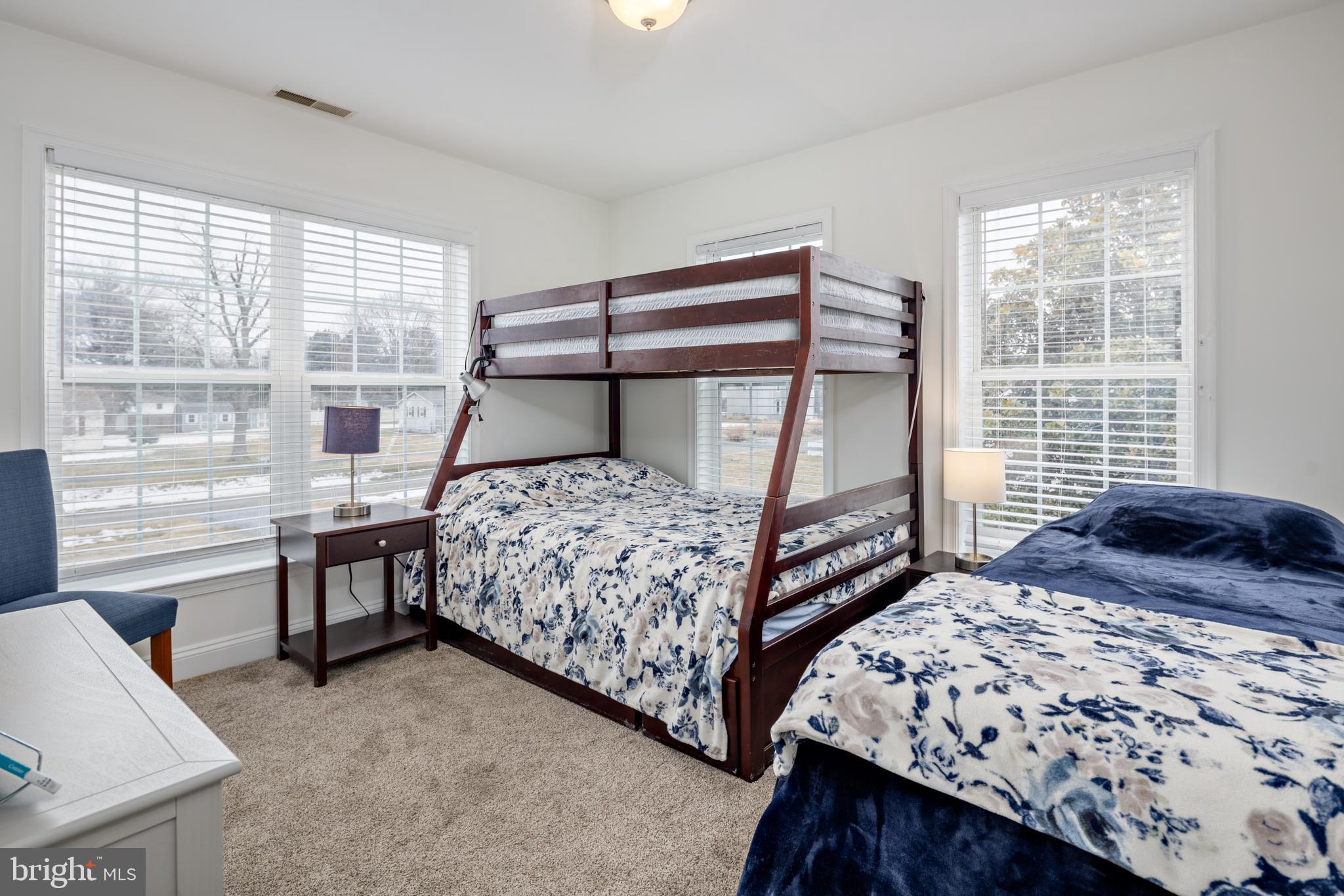 326 South Carolina Road Stevensville, MD 21666 - Photo 31 of 48 a bedroom with a bed a stove and a large window