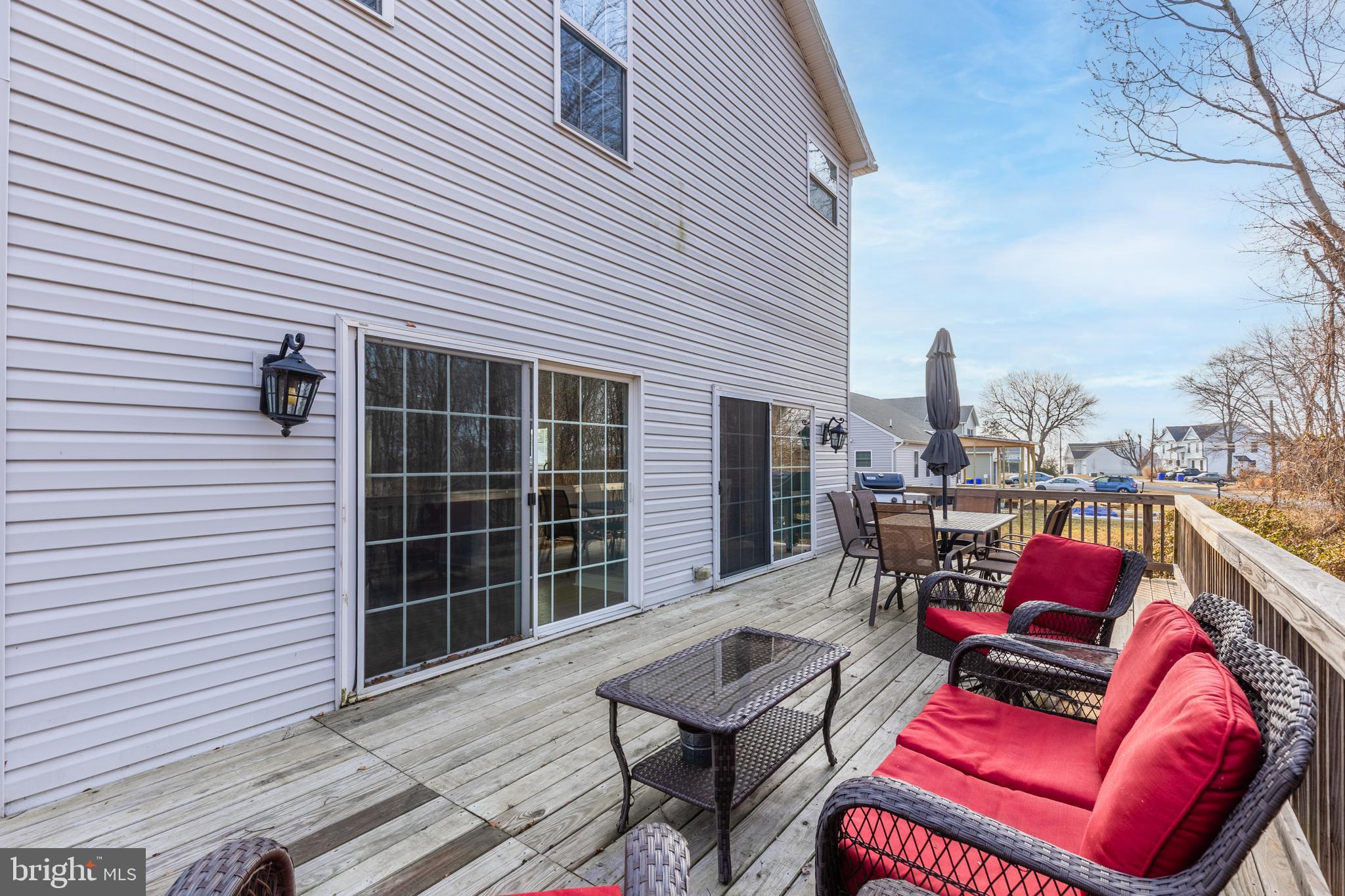 326 South Carolina Road Stevensville, MD 21666 - Photo 32 of 48 a roof deck with a table and chairs and potted plants