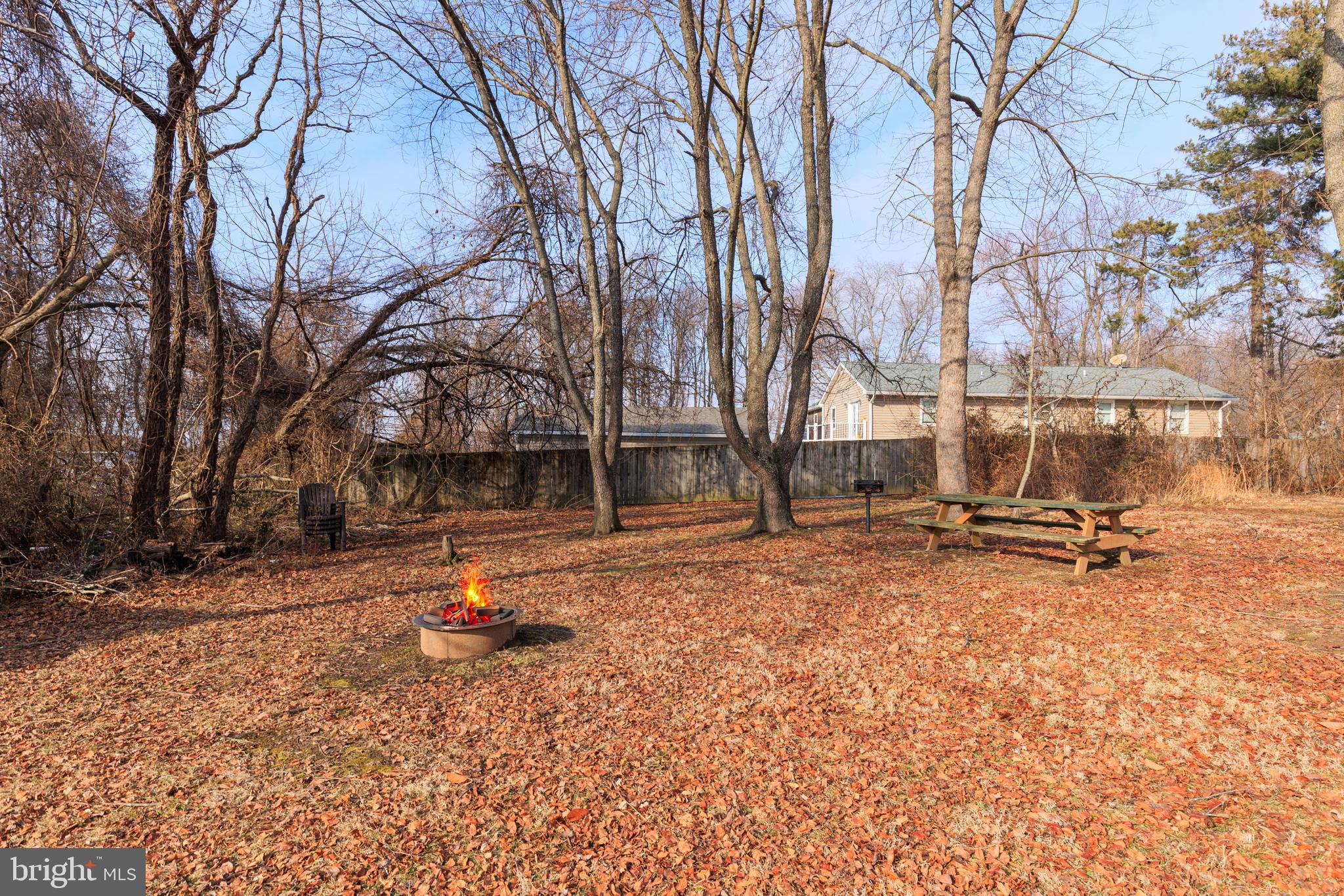 326 South Carolina Road Stevensville, MD 21666 - Photo 35 of 48 a backyard of a house with barbeque oven and trees