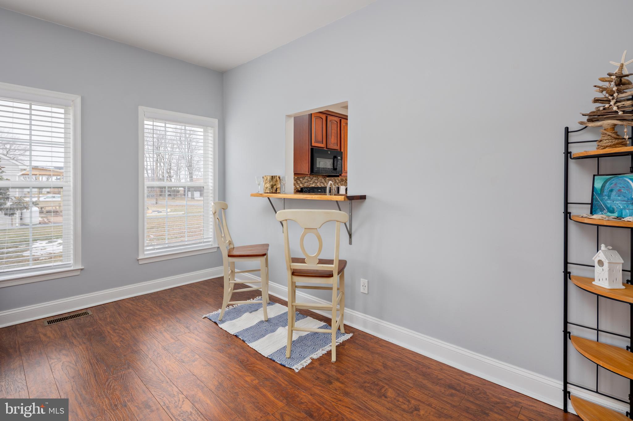 326 South Carolina Road Stevensville, MD 21666 - Photo 7 of 48 a dining room with wooden floor and a window