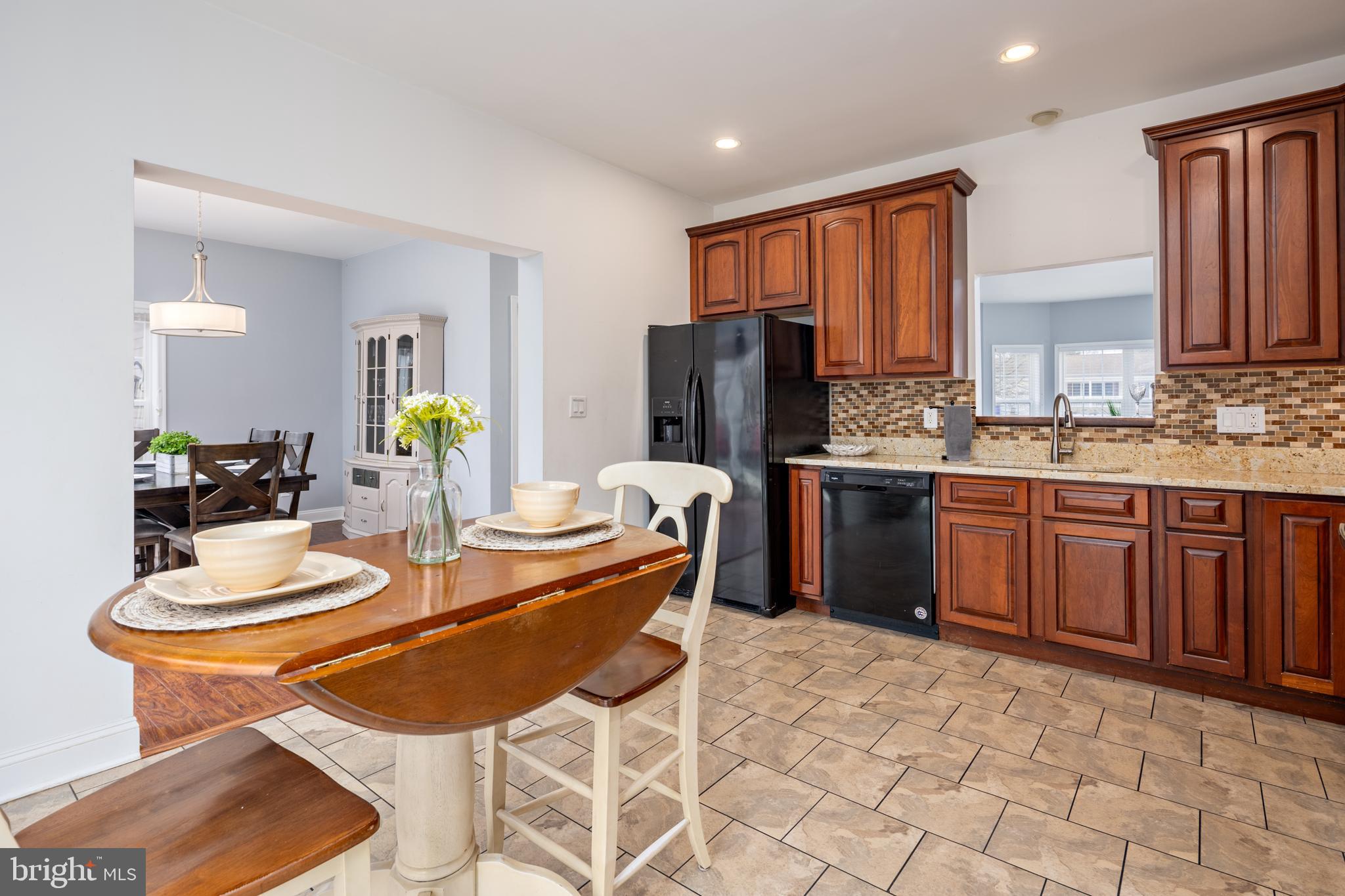 326 South Carolina Road Stevensville, MD 21666 - Photo 9 of 48 a kitchen with stainless steel appliances a sink a stove a refrigerator cabinets and dining table