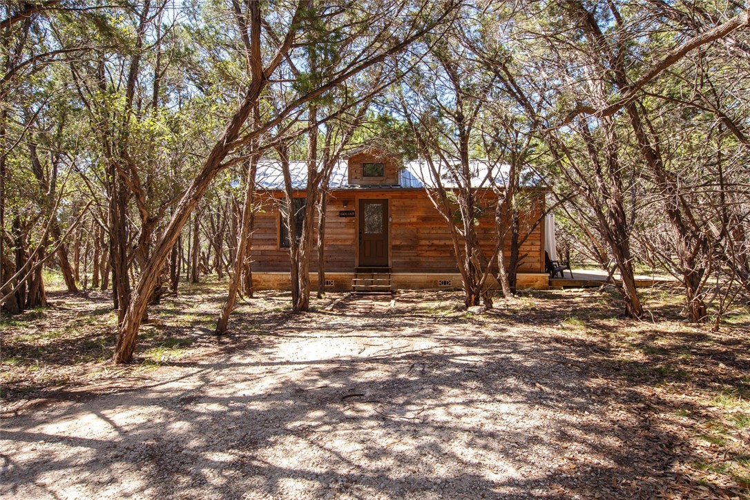 Exterior of Goliad cabin with privacy porch to the right with a hot tub.