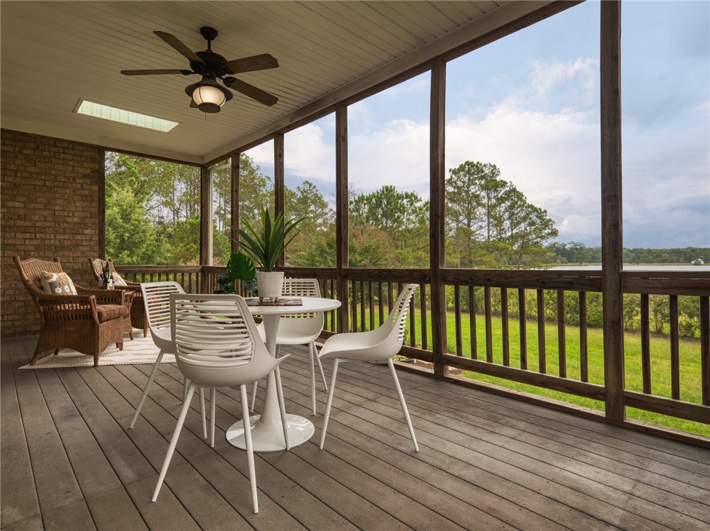 7914 O Neil Road Gloucester, VA 23061 - Photo 41 of 47 Sunroom featuring ceiling fan, a wooden deck, and outdoor dining area