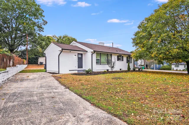 a backyard of a house with table and chairs