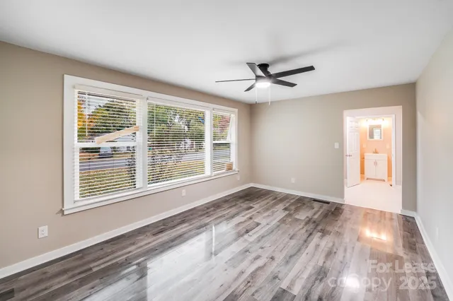 a kitchen with a sink stainless steel appliances cabinets and a window