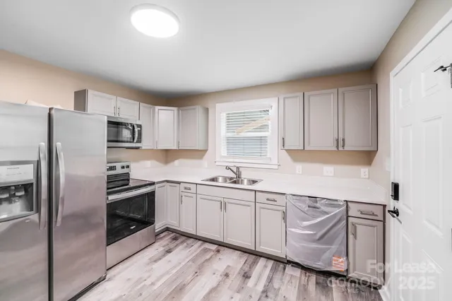 an empty room with a window and a ceiling fan