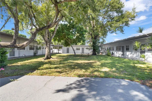 a view of a house with swimming pool and a big yard